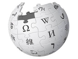 Logo de Wikipédia : globe gris pâle, composé de pièces de casse-tête, chacun avec une lettre de langues différentes (grec, japonais, etc.).