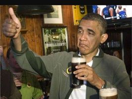 Photo réelle d'Obama avec une bière à la main qui a l'air extrêmement fatigué et/ou saoul, mais néanmoins sympathique et jovial.  Il est dans une taverne.