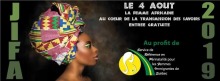 Bannière sur fond noir : JIFA 2019. Photo de la tête d'une femme vue de côté, peau brune, portant un turban haut et coloré. Logo de l'organisme : cercle jaune et route verte.